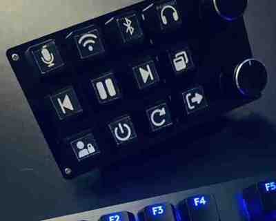 A 12-button, 2-knob macro keypad on a desk.